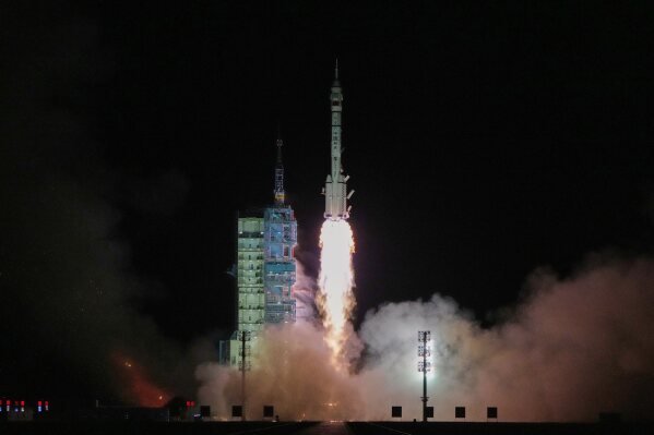 Shenzhou-21 launch showing Long March 2F rocket lifting off from Jiuquan Satellite Launch Center.